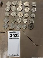 Top view of the 24 American coins arranged on a brown surface.