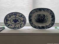 Two blue and white rectangular platters side by side showing overall appearance and designs