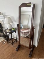 Front and angled side views of the pine cheval mirror showing the full length and overall wood frame construction with base and side supports.