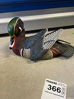 Side view of the Gossett wood duck drake carving showing detailed carving and coloration of the head, neck, and body.