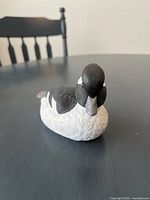 Front view of the signed Bufflehead duck carving decoy showing the black head and detailed white and black painted feathers.