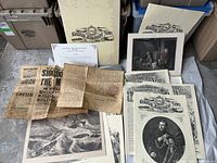 Full overview of collection including Canadian Illustrated News portfolio, historical prints, folded documents, and Abraham Lincoln reward poster.