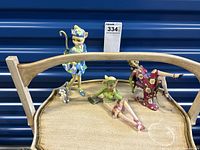 Wide view of all three figurines on wooden tray showing Daisy Doll, Philosopher, and Katy Diva.