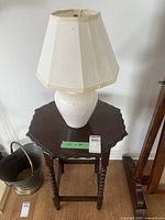 Occasional table with lamp on top, showing fluted edges and turned legs, includes measurement note 28x20.