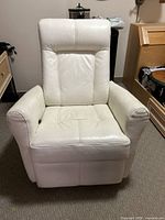 Front view of a winter white leatherette swivel rocker recliner, showing cushions, armrests and seat design.