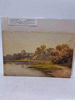 Full front view of the antique watercolour painting showing the landscape scene with houses, water, trees and church tower.