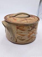 Side angle showing the tureen shape, lid with handle, and spout detail.