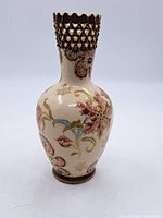 Front view of small antique Satsuma-style vase, showing body with floral and gold hand-painted patterns on cream background.