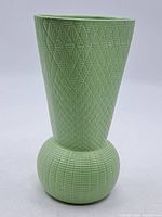 Full view of green vintage ceramic vase with detailed geometric Art Deco patterns and bulbous base transitioning to a wide flared top.