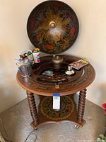 Full view of globe bar cabinet showing open top, barley twist legs and caster wheels