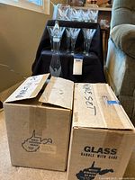 Two original cardboard boxes labeled West Virginia Glass, for the martini and wine sets.