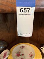 Photo of auction lot tag 657 attached to wooden hutch showing pickup timeslot A