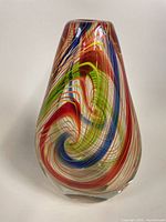 Front view of Murano blown glass vase showing colorful swirl teardrop shape and height.