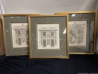 Three framed antique French door cabinet etchings by Charles Le Brun arranged on black fabric showing overall condition and frame details.