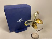 Butterfly figurine with original box behind on a table showing front and box.