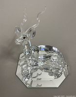 Close-up image of the Swarovski crystal kudu figurine on a mirrored base showing detailed faceting and twisted horns.