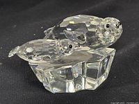 Mama seal and pup seal figurines on faceted iceberg crystal base, black eyes detail