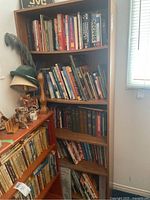 Five shelves of books including textbooks, aviation, novels, Canadiana, and Pierre Berton books.