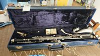 Clarinet and accessories arranged in open blue velvet-lined case