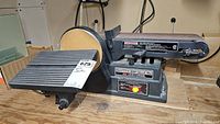 Photo of the Craftsman motorized belt and disc sander with label showing item number and lot tag.