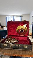 French horn and detachable bell in open fitted case
