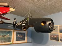 RC P-47 Thunderbolt fuselage suspended from ceiling showing front nose opening and overall condition