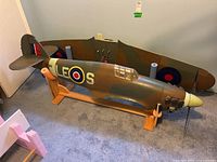 Left side view of Hawker Hurricane fuselage with detached wings standing behind