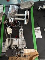 Overview of engine, muffler and additional exhaust pieces laid out on table