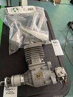 Engine and sealed Bisson muffler in plastic bag on table