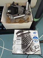 Open box displaying unmounted engine with finned head and crankcase