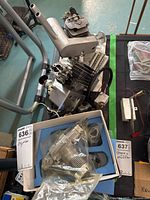 Three RC plane engines and various accessories displayed