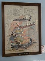 Full view of framed poster with aircraft illustrations and signatures.
