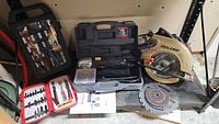 Full lot view showing the multi tool kit, skilsaw circular saw, socket set, and utility cutter set with extra saw discs.