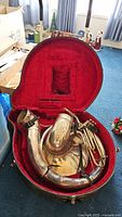 Open case showing entire tuba body and red plush lining