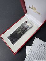 IM Corona silver-tone ribbed lighter in original branded red case with warranty papers.