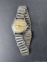 Full view of the vintage Titus wristwatch with Forstner Bonklip bracelet on black background.