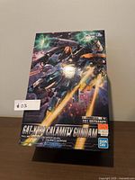 Front of the box showing branded full mechanics 1/100 Calamity Gundam image with action artwork and model designation.