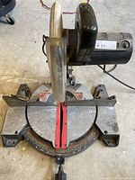Front view of Craftsman 12-inch miter saw showing base with angle gauge and attached blade covered by guard.