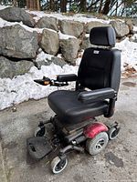 Three angled views of the Vision Sport mobility scooter showing black seat, armrests, joystick control, footrest, wheels, and red fenders. Scooter is used with dirt and rust visible.