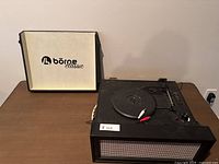 Borne Classic portable record player with lid open showing logo inside and turntable with controls visible.