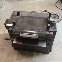 Top view of the black metal Sears Canada planer showing handles and overall design.