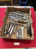 Wide view of all wrenches in cardboard box showing various sizes and types.