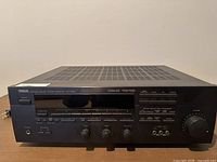 Front view of Yamaha Natural Sound stereo receiver showing digital display, front controls and headphone jack