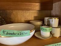 Porcelain bowl with 9-inch diameter and 2.5-inch height, white with gold trim.