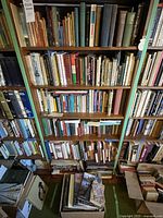Bookshelves filled with a large variety of books in different genres and formats, showing the volume and scope of the collection.