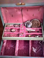 Box interior with pink velvet compartments showing all items