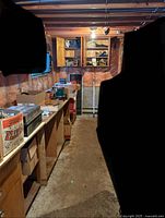 Overview of vintage workshop space with cluttered shelves and boxes containing tools and materials