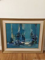 Front view of framed print showing mid-century abstract design in turquoise tones within gold frame