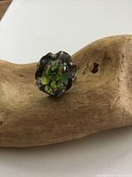 Vintage Mexican sterling silver and opal ring displayed on wooden stand, showing front and side views.