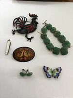 Top-down image showing all vintage jewelry pieces arranged on a white background.